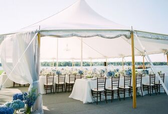 Outdoor wedding reception under a round open-air tent