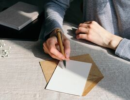 Woman writing wedding invitations