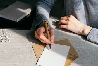 Woman writing wedding invitations