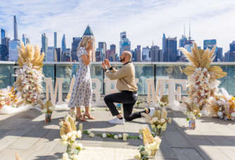 Masn proposing to woman next to bridge in New York City