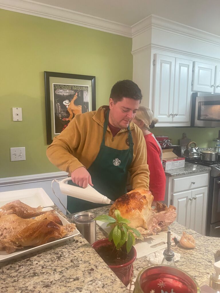 Brandon cutting the meat for Christmas fest