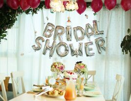 Bridal shower balloons and table set up with florals and drinks