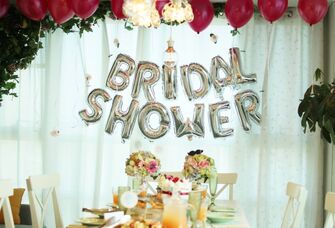 Bridal shower balloons and table set up with florals and drinks