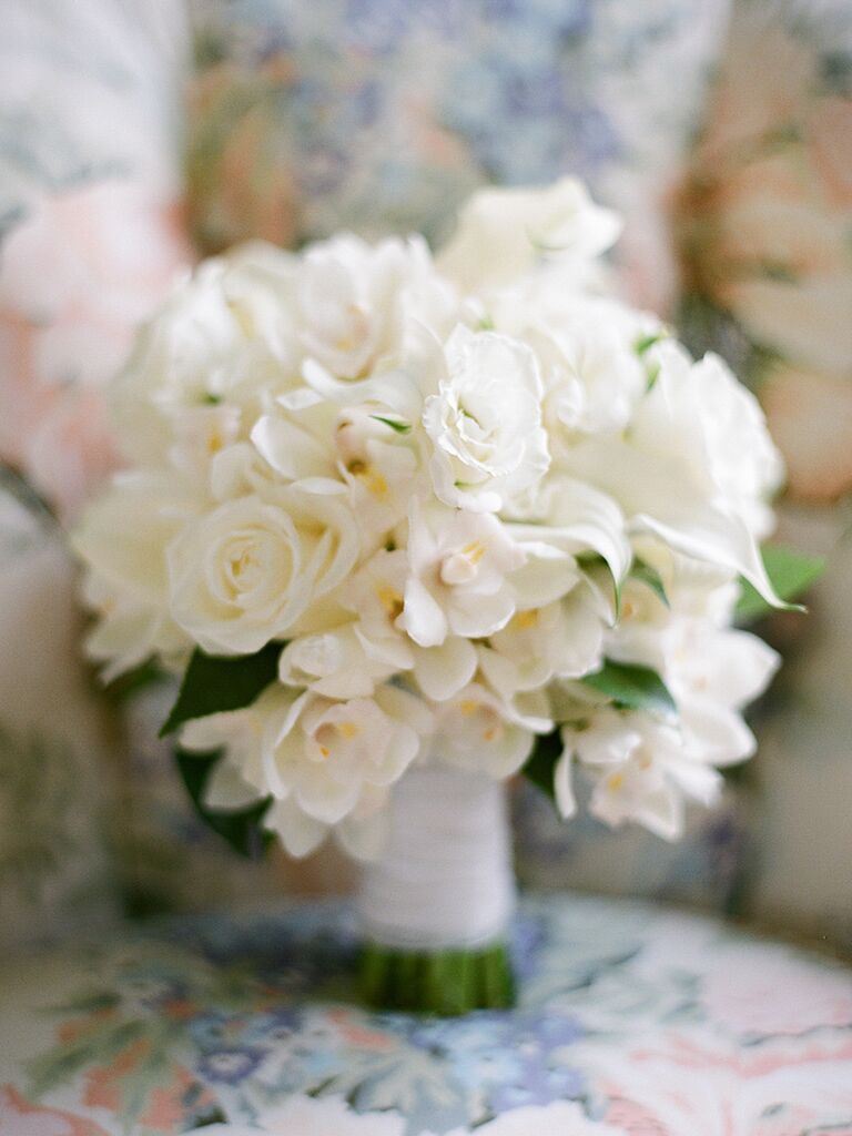 Romantic white wedding bouquet with orchids, calla lilies and roses