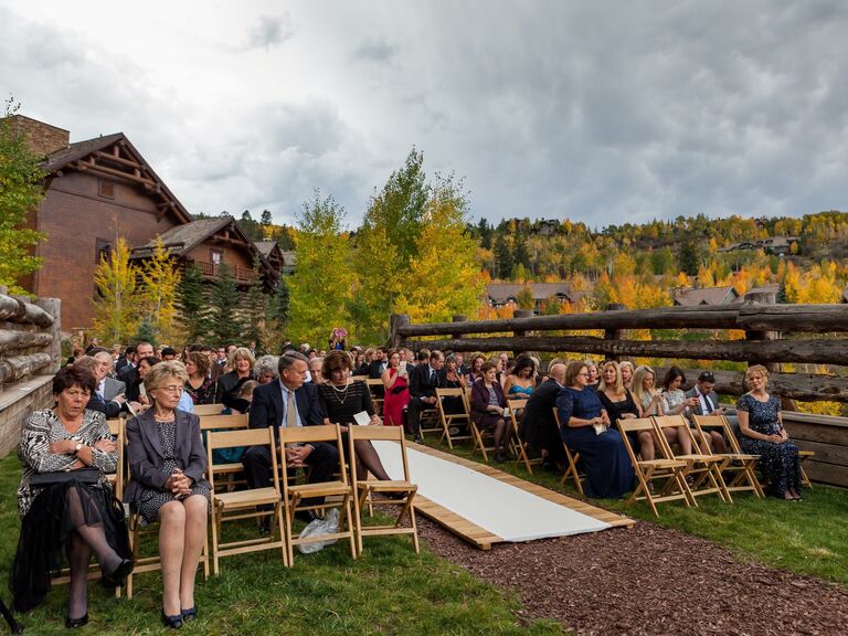 Wooden aisle runner at an outdoor ceremony in the wilderness. 