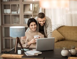Couple using laptop at home 