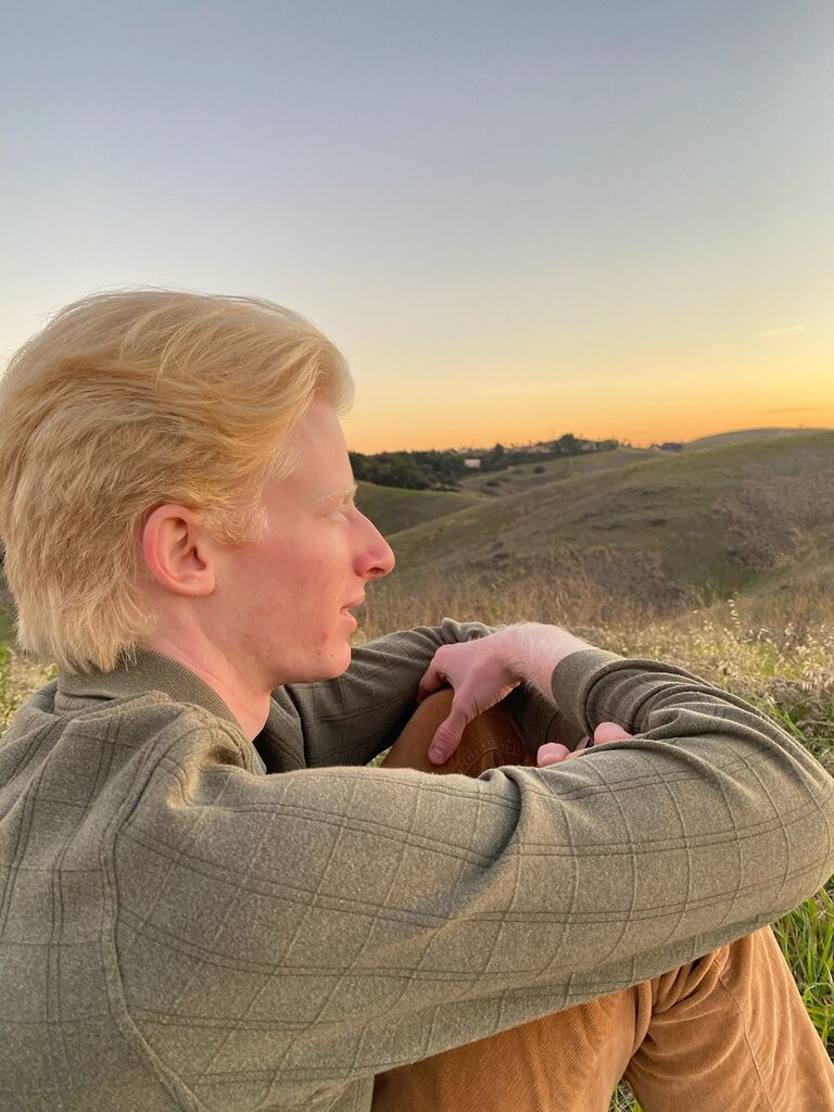 We sit on a hill on our first date.
