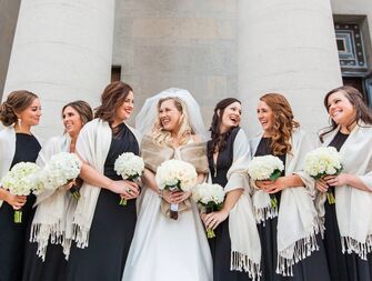 group of bridesmaids wearing white wraps