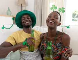 Couple drinking beer and wearing St. Patrick's Day attire