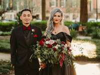 Couple dressed in black at their Halloween-themed wedding