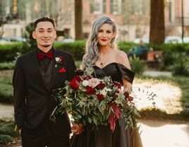 Couple dressed in black at their Halloween-themed wedding