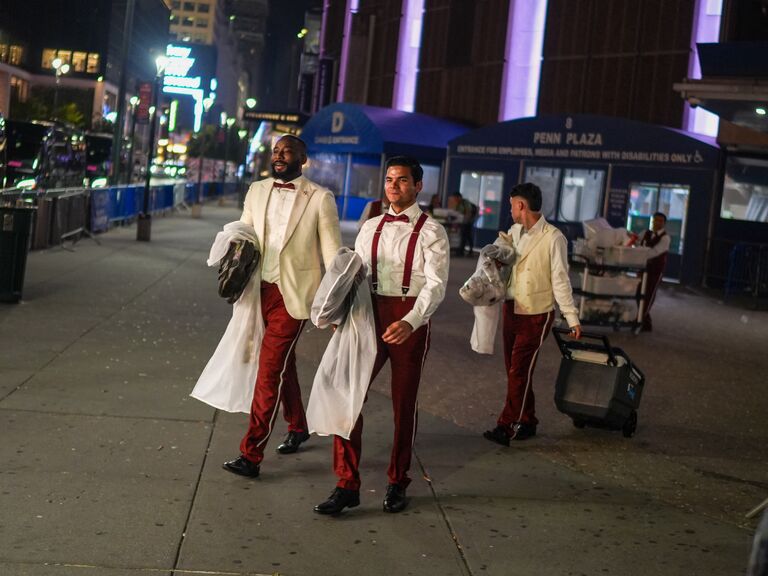 Believed to be catering staff leaving the rehearsal dinner at Madison Square Garden around midnight in red pants, suspenders and bow ties.