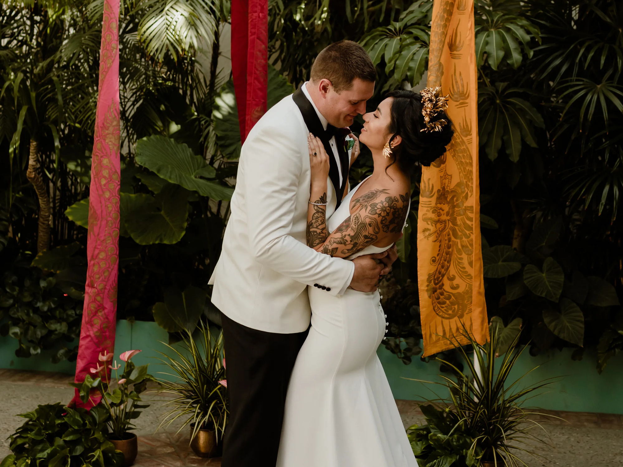 Bride and groom in front of Balinese flags on wedding day