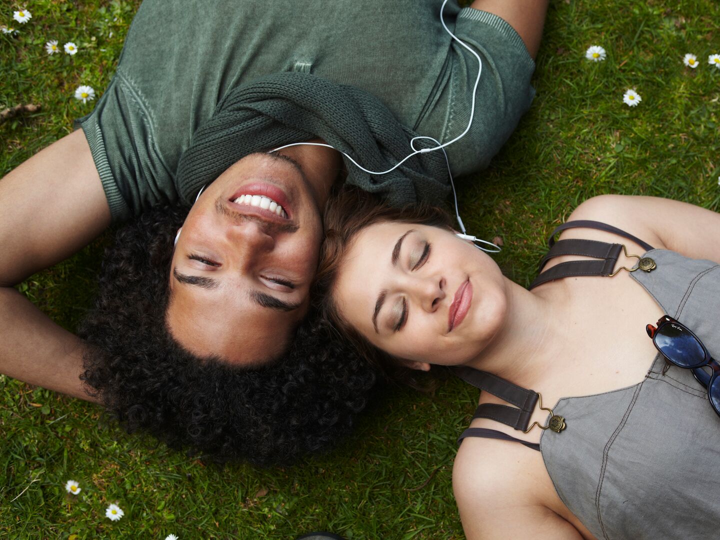 song lyrics for captions - young couple sharing headphones