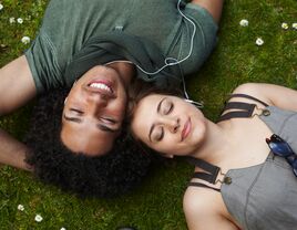 Young couple sharing headphones