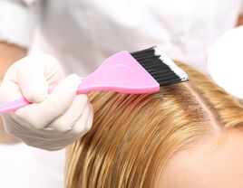 woman getting highlights in salon chair