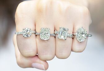 Woman wearing different styles of engagement rings