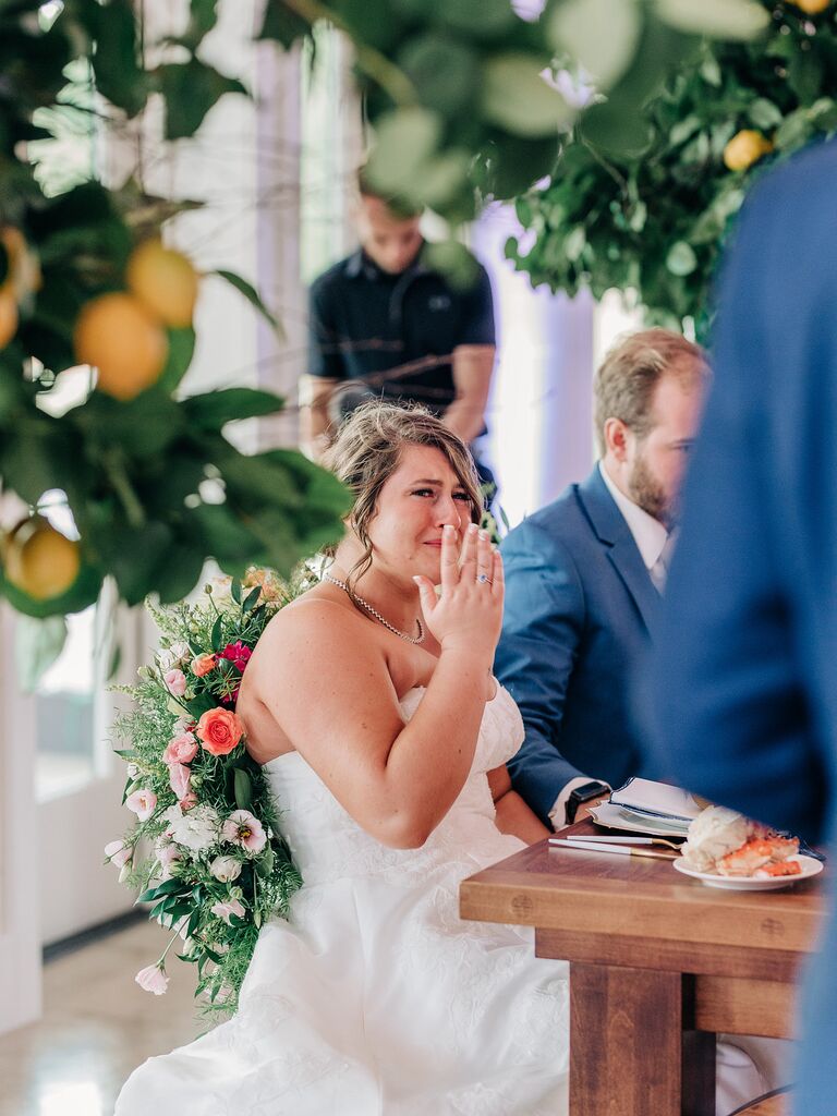 Bride crying during touching toasts at wedding reception