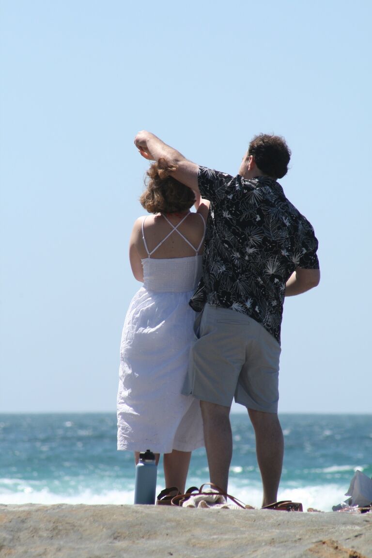 They spent the morning curating the perfect picnic. After picking up a bottle of wine from the local grocery store, they stopped by the Carmel Cheese Shop for cheese and crackers, and finally visited the local bakery for some fresh-baked pretzels. With the picnic basket packed and ready, they strolled down the beach, admiring the stunning ocean views along the way.