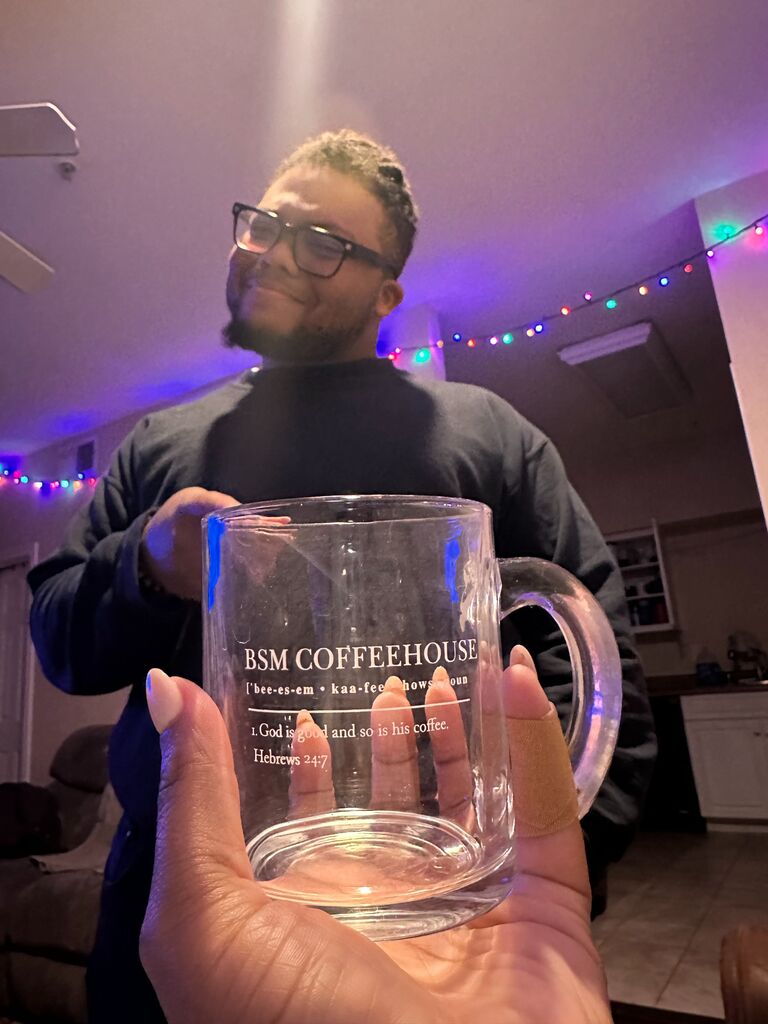 During Welcome Week at Dallas Baptist University, Joshua met Jo while she helped host the annual BSM Coffeehouse event. Jo convinced Joshua to buy the mug she designed, though he playfully teased her by not believing she designed the mug. They went on about their evening, not meeting again until a few months later. 