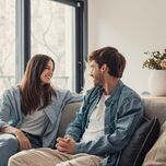 Young couple talking on a couch