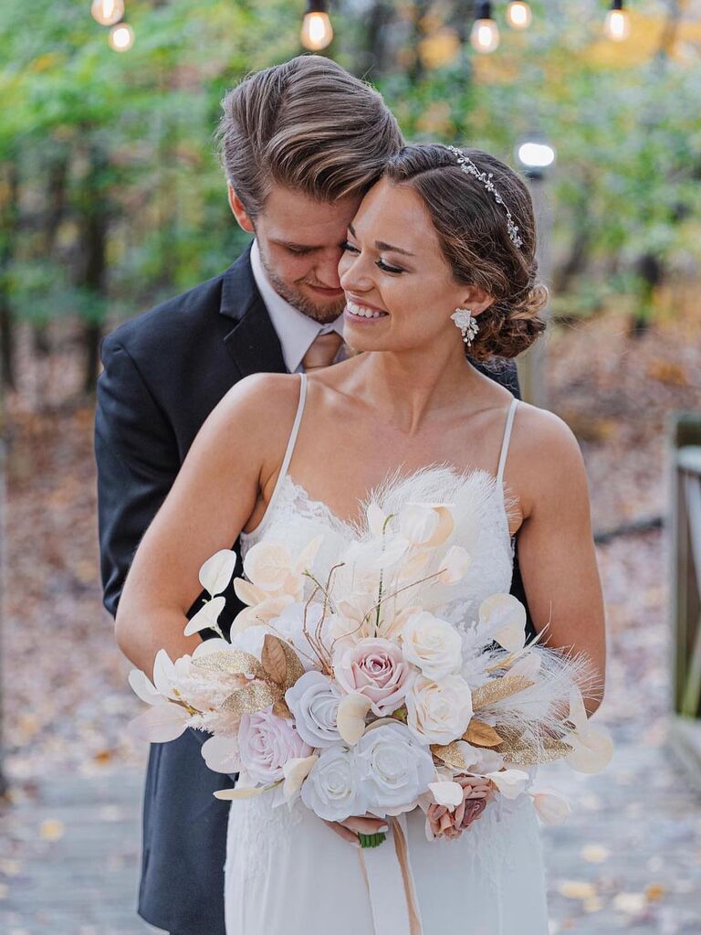 Couple happily holding onto each other for wedding portrait