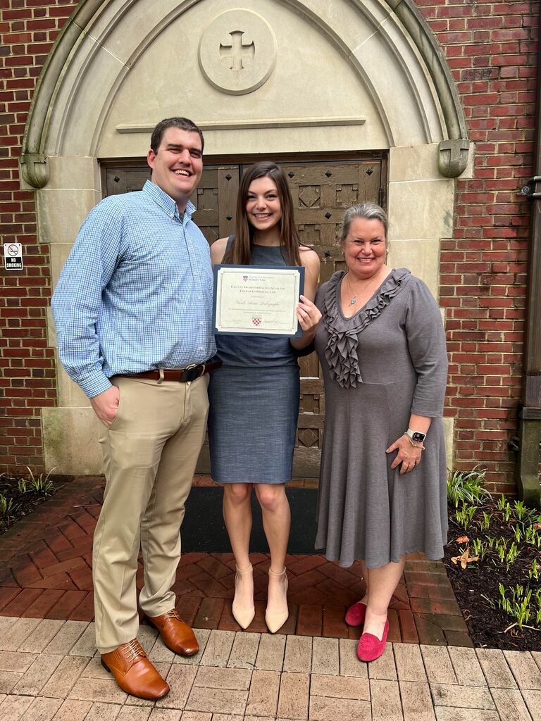 Austin and his mom attend Nicole's law school award ceremony.
