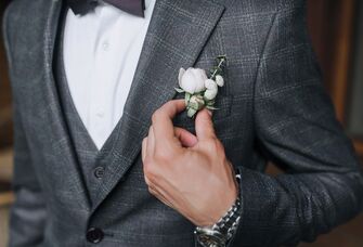 Man fixing his boutonniere