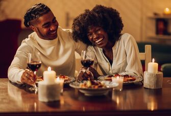 Happy couple laughing while having dinner