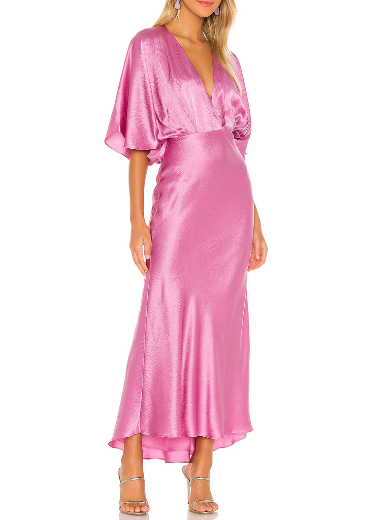 A model wears this retro V-neck pink wedding guest dress.