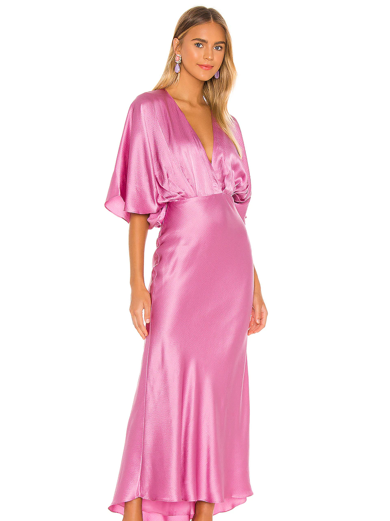 A model wears this retro V-neck pink wedding guest dress.