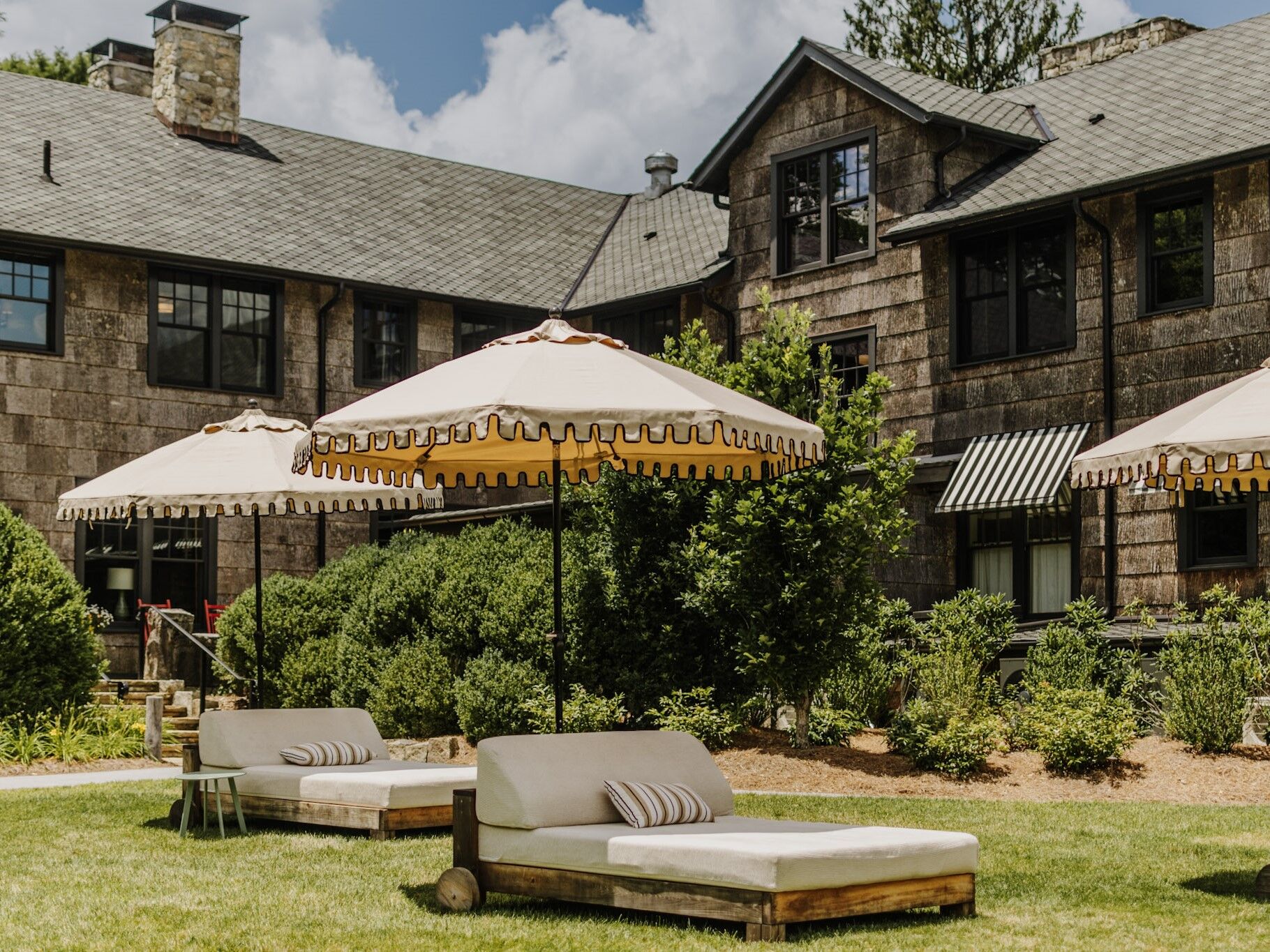 Outdoor lounge area beside a stone venue