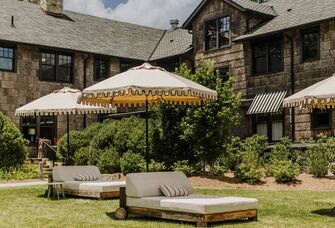 Outdoor lounge area beside a stone venue