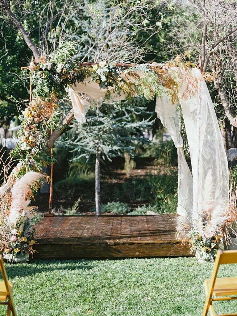 Rustic arch with dried grass and linen draping