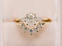 vintage-looking three-stone oval engagement ring 