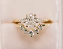 vintage-looking three-stone oval engagement ring 