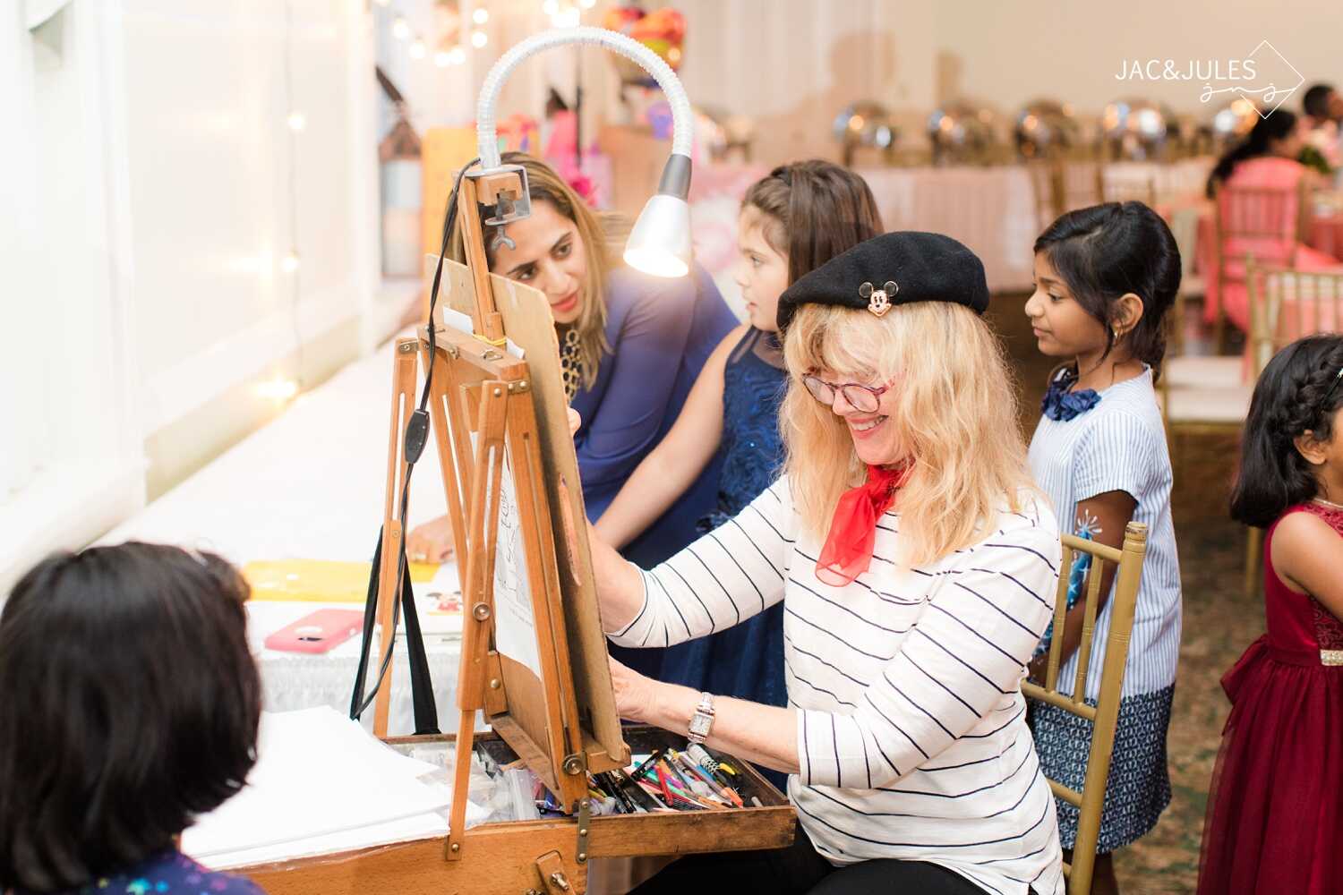 Caricaturist dressed in Parisian clothes drawing at a kids party