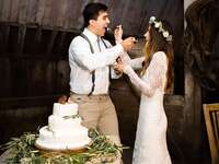 Bride and groom feeding each other wedding cake.