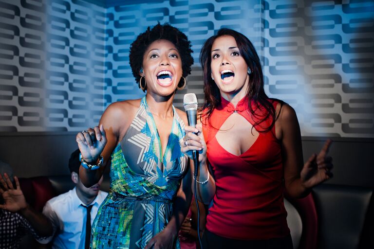 Two Girls Singing Karaoke Photo - Getty Images