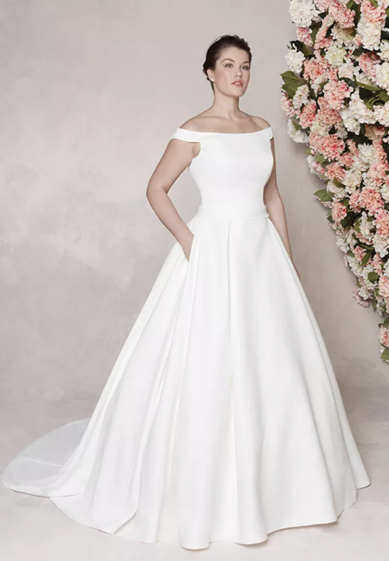 Satin ball gown with an off the shoulder neckline, chapel length train, and pockets