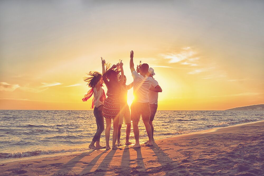 friends dancing on the beach