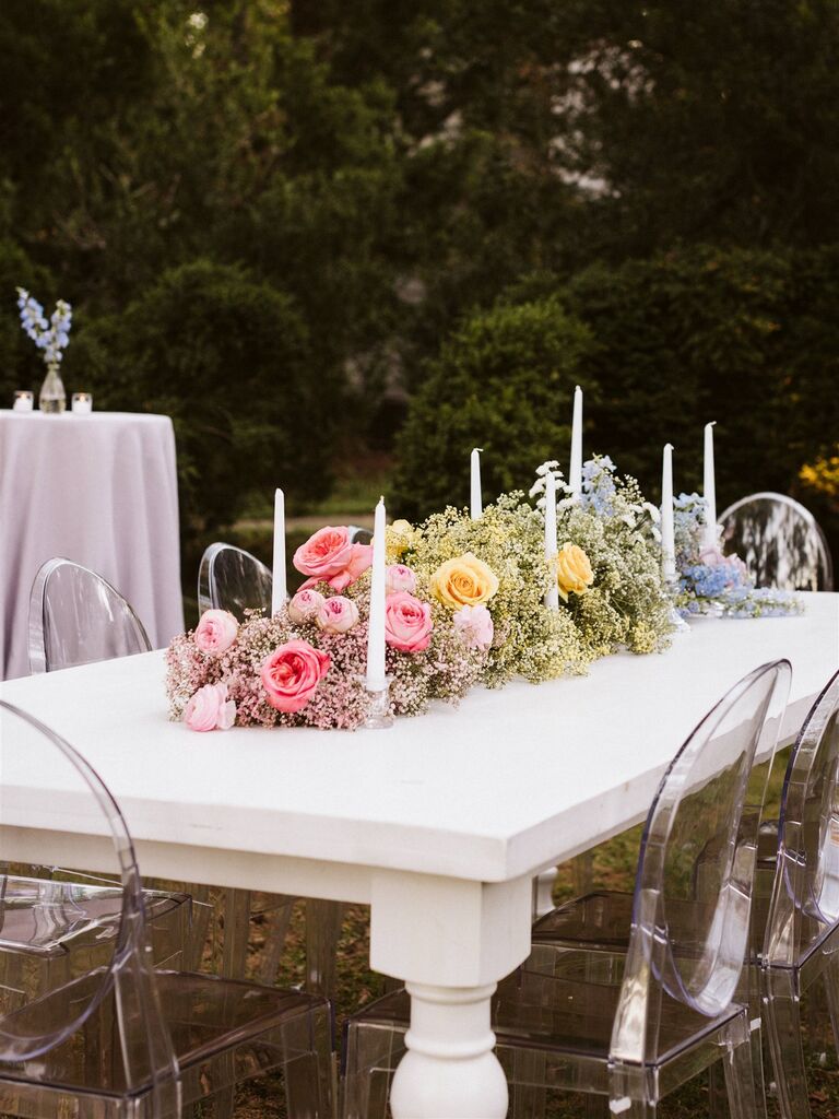 unique wedding centerpiece idea with rainbow colored baby's breath and flowers in ombre design