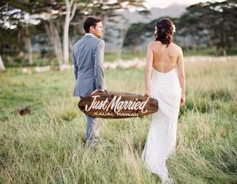 Hawaii couple holding just married sign