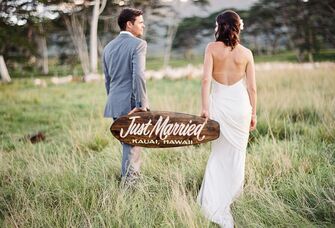 Hawaii couple holding just married sign