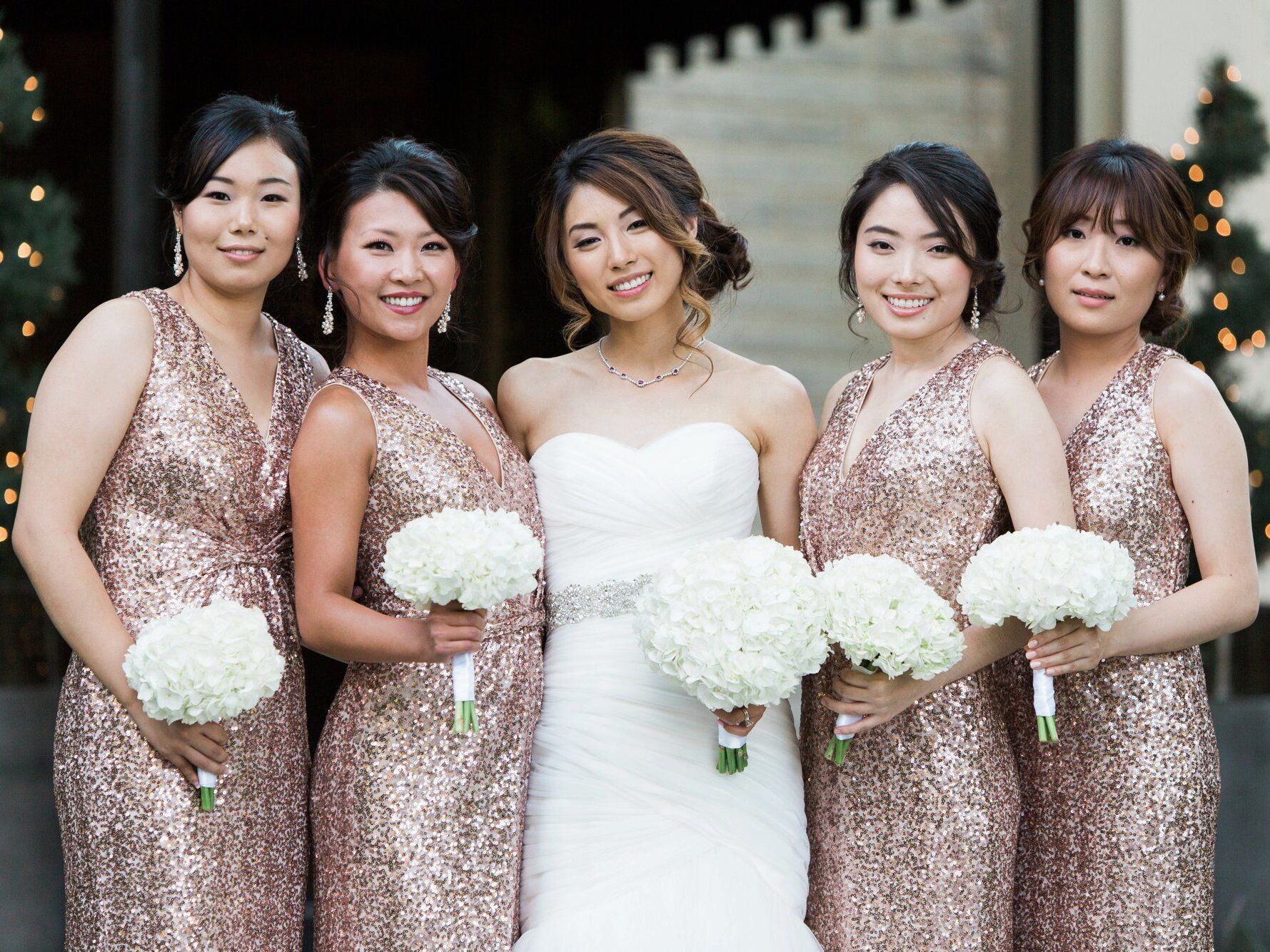 Bride with bridal party in rose gold sequin bridesmaid dresses