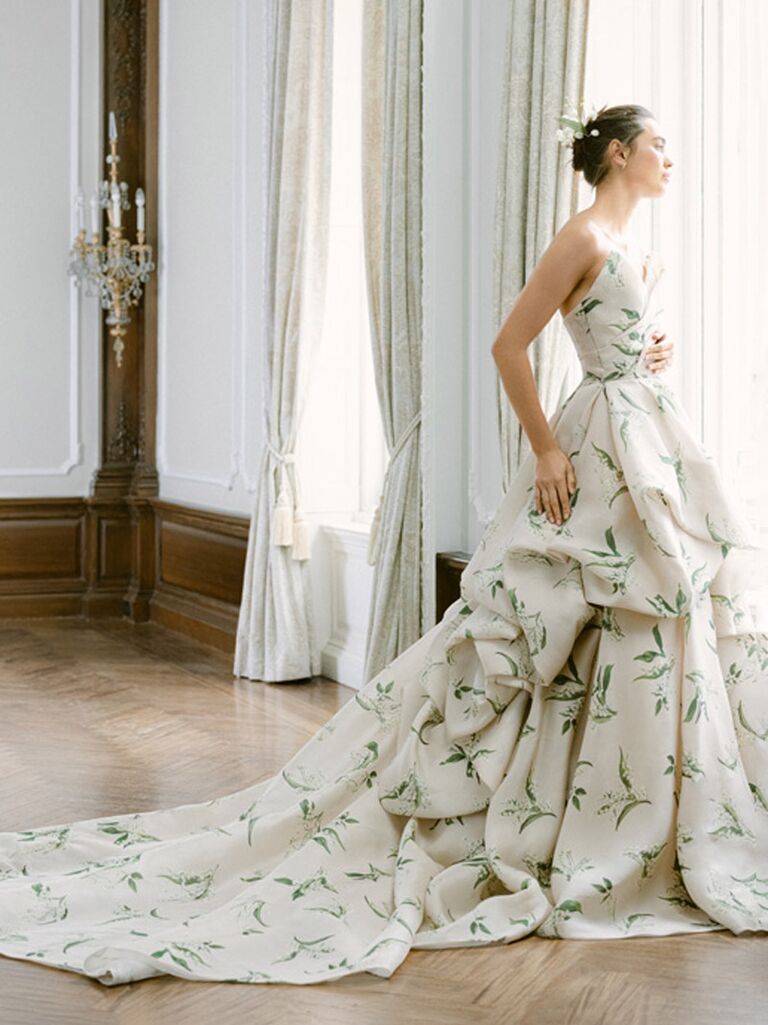 monique lhuillier strapless wedding dress with leafy green print and flowy ruffled ball gown skirt
