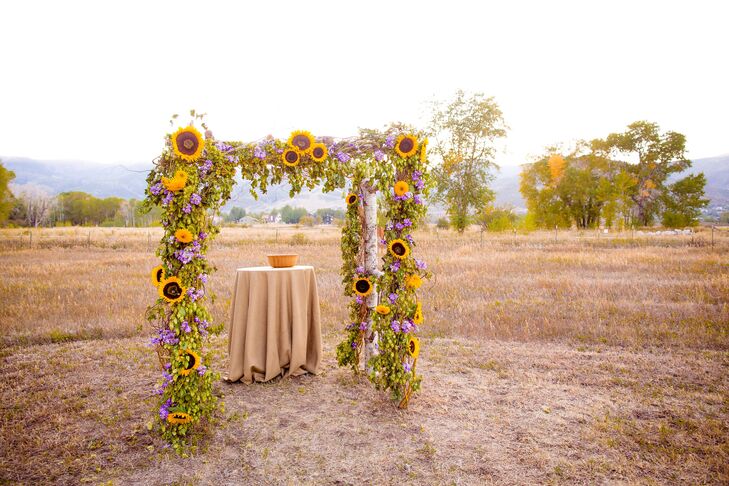 The ceremony arch was a framed pergola lined with an arrangement of sunflowers and lavender.