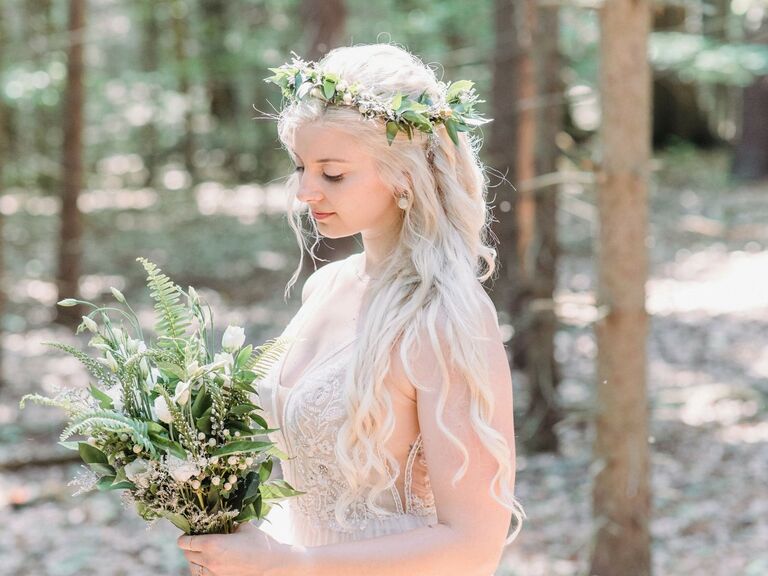 Bride wears her hair in loose long waves with a flower crown. 