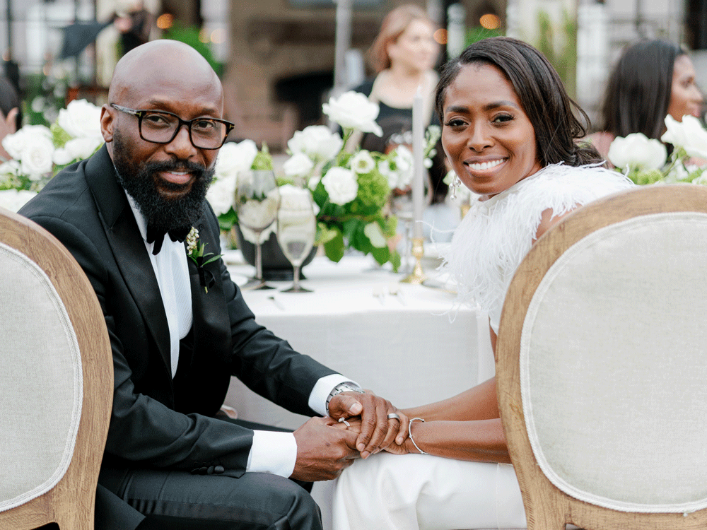 Bride and groom at wedding head table.