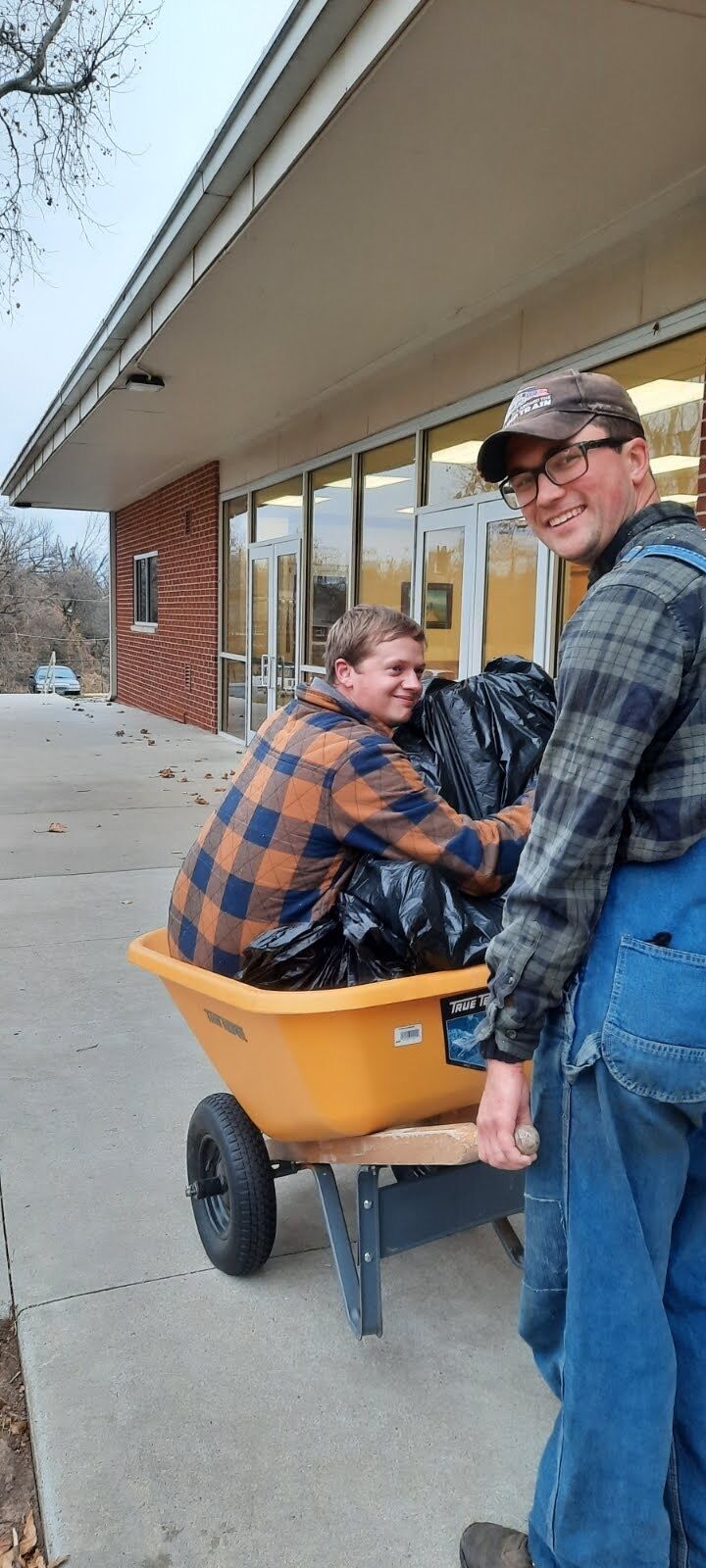 Josh said he would take a ride in the wheel barrel and say, "bye" to the trash and grounds for the last time.
